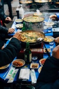 A vibrant dining table with Korean dishes and drinks, capturing authentic Seoul street food culture.